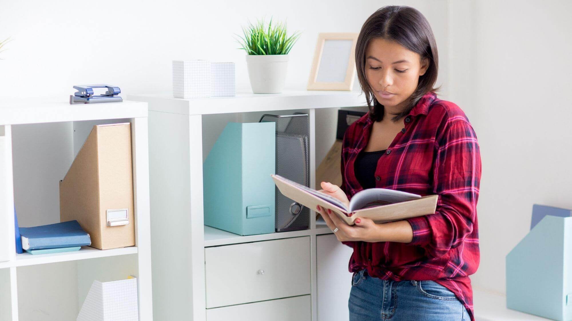 A woman standing in front of a refrigerator